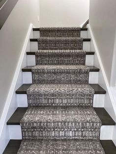 carpeted stairs leading up to the second floor