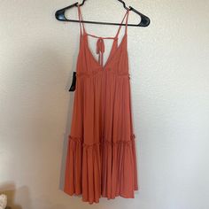 It’s A Coral/Salmon Colored Flowy Boho Dress. I Love This Dress, It Just Didn’t Fit Me Right. New With Tags, No Stains Or Tears. Peach Sundress Mini Dress For Day Out, Sleeveless Peach Mini Dress For Day Out, Peach V-neck Mini Dress For Beach, Pink Flowy Sundress For Date Night, Casual Peach Mini Dress For Beach, Peach Casual Mini Dress For Beach, Casual Peach Mini Dress For The Beach, Peach Casual Midi Dress For Summer, Casual Peach Midi Dress For Summer