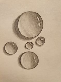 a pencil drawing of three bubbles on a piece of paper