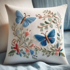 a decorative pillow with blue butterflies on it