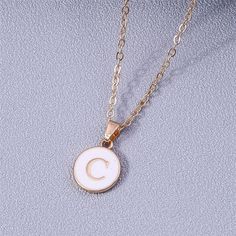 Add a personalized touch to your look with our YourLetter White Enamel Circle Necklace. Crafted with a white enamel background and gold color detailing, the necklace comes with a choice of single letter pendant. A great way to show off your initials or those of someone you love. Necklace For Women Gold, Alphabet Pendant, Alphabet Necklace, Trendy Necklace, Letter Pendant Necklace, Name Initials, Single Letter, 26 Letters, Trendy Necklaces