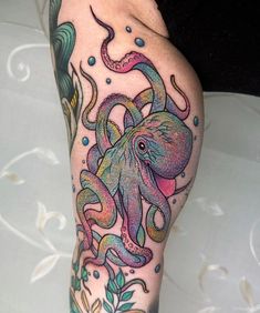 an octopus tattoo on the leg of a woman