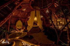 the inside of a hut with candles lit up