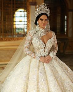 a woman in a wedding dress with a tiara on her head and veil around her neck