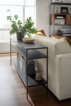 a living room with a couch, coffee table and bookshelf