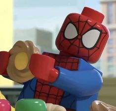 the lego spider - man character is playing with his toys