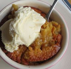 a bowl filled with ice cream and some kind of dessert on top of a table