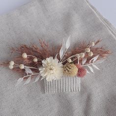 Our Handmade Dried Flower Hair Comb is perfect for any bride or bridesmaid looking to add a touch of floral elegance to their wedding day look. If you're planning a boho-themed wedding, this hair accessory is a must-have. Crafted with real dried flowers, this hair comb features a beautiful combination of delicate blooms and foliage in a stunning blush white champagne color. The intricate design of the comb is natural and elegant, adding a romantic and whimsical touch to any hairstyle. This Brida Boho Hair Piece Wedding, Floral Hair Piece Wedding Bohemian Bride, Dried Floral Hair Piece Wedding, Boho Wedding Hair Comb, Blush Champagne Wedding, Bridal Flower Comb Boho, Dried Flower Hair Comb Wedding, Bridesmaid Hair Flowers, Bridesmaid Hair Pieces