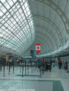 people are standing in an airport waiting for their luggage to arrive or leave the terminal