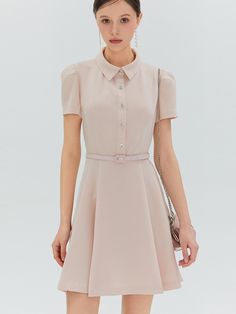 The Elina Mini Dress is a testament to classic elegance, designed with a sharp collar and a flared skirt. The belted waist and distinctive button detailing create a look that is at once modern and timeless. - The dress’s structured collar and sleek short sleeves impart a professional yet feminine look.- A series of sparkling buttons descend down the front, providing a striking contrast against the dress’s dark fabric.- Its cinched waist, accented with a slim belt, highlights the figure and adds to the dress’s tailored appearance.- The flare of the mini skirt brings a playful touch to the silhouette, making it suitable for both day and evening wear. Classic Belted Shirt Dress For Semi-formal Occasions, Elegant A-line Shirt Dress With Button Closure, Elegant A-line Mini Dress With Pleated Waist, Fitted Mini Shirt Dress For Formal Occasions, Elegant A-line Dress With Buttons, Classic A-line Belted Dress For Formal Occasions, Elegant A-line Midi Dress With Belt, Chic Semi-formal Belted Mini Dress, Formal Mini Dress With Fitted Waist