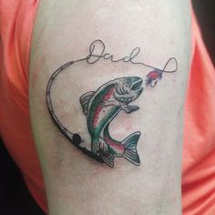 a woman with a tattoo on her arm has a fish hooked up to a fishing rod