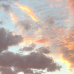 an airplane is flying in the sky at sunset