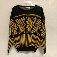 Black and yellow, black and yellow!  You know what it is!  An awesome sweater (awesome sweater). Details: 100% Acrylic Made in 1970s (70s) Made in USA Size: Women's Medium (M) Brand: Glamour-Knit Condition: Very good  Machine or hand wash warm Main colors: Black, yellow Measurements: Chest 44.5 in Length  23.5 in Shoulder 25 in Disclaimer:  It is the buyer's responsibility to wash the article of clothing before wearing it.  Any mishaps that may occur due to wearing the clothing before washing it are the responsibility of the buyer and not TheGreatAdvintage.  (The shirts have been washed and cleaned beforehand, but still wash it before you wear it!) My collection consists of pieces that are of vintage condition, which means that all my items are second-hand and used. Customers are not purch Winter Yellow Jacquard Knit Sweater, Yellow Jacquard Knit Sweater For Winter, Yellow Crew Neck Sweater For Winter, Yellow Knitted Crew Neck Sweater, Retro Yellow Crew Neck Sweater, Vintage Black Fitted Sweater, Black Crew Neck Sweater With Fair Isle Pattern, Vintage Black Sweater For Fall, Vintage Black Winter Top