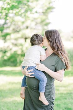 a woman holding a baby in her arms