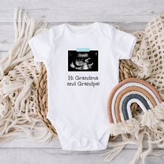 "This personalized baby outfit is a sweet way to announce your miracle on the way. Personalize it with your own ultrasound, a phrase of your choice, and the color of the \"tape\" that holds the ultrasound up (blue, pink, or yellow). HOW TO ORDER: * Select the color and size you want and add the item to your cart * Enter your personalization: What phrase you want and what color \"tape\" - blue, pink, or yellow * After purchasing, send me a message with your ultrasound photo (make sure to include Personalized Fitted Onesie For Gender Reveal, Personalized White Onesie For Father's Day, Customizable White Onesie For Gender Reveal, White Onesie With Letter Print For Gender Reveal, Customizable White Bodysuit For Gender Reveal, Personalized White Onesie As A Gift, Personalized White Bodysuit For Gift, Customizable White Onesie As A Gift, Personalized White Onesie As Gift