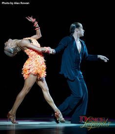 a man and woman dancing on stage together