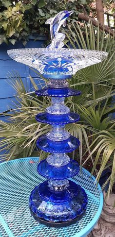 a blue glass fountain sitting on top of a table