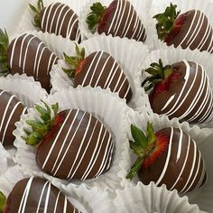 chocolate covered strawberries are arranged on white paper wrappers, ready to be eaten