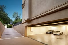 two cars are parked in an empty garage