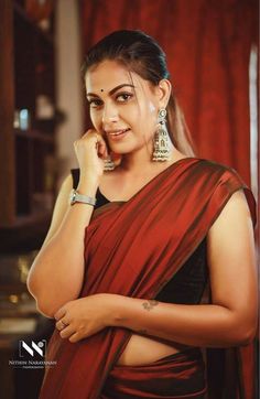 a woman in a red sari talking on her cell phone