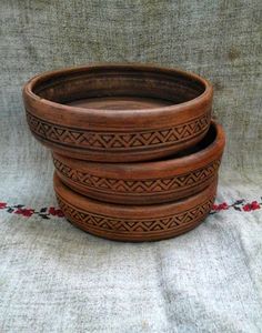 three wooden bowls sitting on top of a table