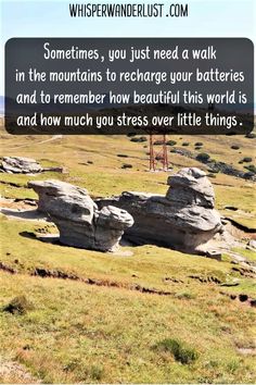 some rocks in the middle of a field with a quote on it that says sometimes, you just need a walk in the mountains to recharge