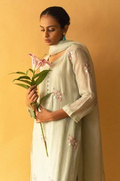 Ice green kurta with resham, zari floral embroidery and potli button detailing. Paired with pant and dupatta.
Components: 3
Pattern: Embroidered
Type Of Work: Floral
Neckline: Round
Sleeve Type: Three quarter
Fabric: Kurta: cotton chanderi, Dupatta: kota silk, Pant: bamboo cotton
Color: Green
Other Details: 
Cutwork border detailing
Attached lining
Occasion: Puja - Aza Fashions Green Floral Embroidery Churidar, Festive Pista Green Palazzo Set With Floral Embroidery, Festive Pista Green Floral Embroidered Palazzo Set, Green Slub Silk Unstitched Suit With Chikankari Embroidery, Green Unstitched Slub Silk Suit With Chikankari Embroidery, Green Churidar With Floral Embroidery In Chanderi, Green Chanderi Churidar With Floral Embroidery, Green Chanderi Palazzo Set With Floral Embroidery, Pista Green Cotton Silk Sets With Floral Embroidery