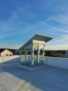 an empty roof with a small glass door on it