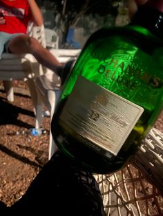 a green bottle sitting on top of a white chair