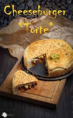 a cheeseburger torte on a cutting board with one slice missing from it