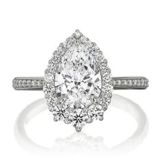 an oval cut diamond ring with pave set shoulders