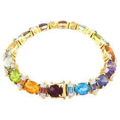 This is a new without tag custom made Sophisticated Multi Natural Oval Cut Gemstones Ladies Bracelet in 18K Yellow Gold. One of a kind model of bracelet. Offers a very elegant, tasteful and stylish look on a woman's hand. The gemstones (Garnet, Amethyst, Citrine, Blue Sapphire) are all natural, untreated and with a very careful oval cut. The bracelet is in 18K Yellow Gold. Its total weight is 32.6 grams. Measurements: length 7.2 Inches or 19 centimeters, the with is 10.6mm. The diamond is approx Ladies Bracelet, Oval Cut, Link Bracelets, Womens Bracelets, Citrine, Blue Sapphire, Garnet, Jewelry Bracelets, Sapphire