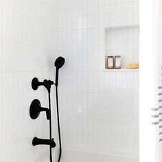 a white bath tub sitting next to a shower head