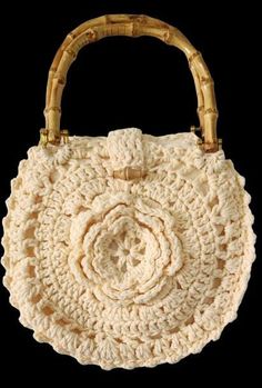 This stunning handmade crochet purse is the perfect blend of craftsmanship and boho-chic style. The intricate flower pattern on the front adds a unique and feminine touch, while the sturdy bamboo handles provide an eco-friendly and stylish feature. Made with soft beige yarn, this round crochet tote is versatile enough for casual outings, beach trips, or brunch with friends. - Unique Floral Design: A beautifully crocheted flower centerpiece gives this handbag a charming and artisanal feel, perfect for those who appreciate handmade accessories. - Eco-Friendly Bamboo Handles: The natural bamboo handles are not only durable but also add a rustic, eco-conscious element to the bag. - Lightweight and Comfortable: Easy to carry, this bag is lightweight yet sturdy, making it ideal for carrying your Crochet Flower Purse, Unique Floral Design, Round Crochet, Crocheted Flower, Flower Purses, Flower Centerpiece, Crochet Purse, Beach Trips, Soft Beige