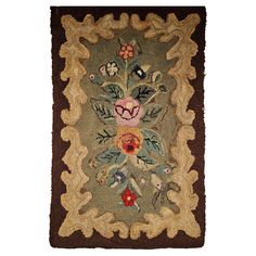 an antique rug with flowers and leaves on it