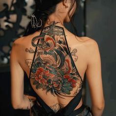 the back of a woman's body with tattoos on it