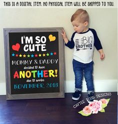 a little boy standing next to a chalkboard that says i'm so cute