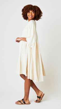 A dramatic one sized dress crafted from the softest hand spun woven cotton. Voluminous, flowing and relaxed silhouette makes a "cool" piece for southeastern fall weather. Heritage styling, raglan elbow length sleeves and densely gather skirt that falls to knee-length. Fabric Content: 100% hand spun, hand woven cotton Care Instructions: Gentle hand wash in cold water. Do not soak. Drip dry in shade. Imported Measurements (Inches) One Size Length 42" Sleeve Length 16" Measurements are approximate. Oversized Knee-length Dress For Daywear, Oversized Knee-length Day Dress, Bohemian Midi Dress Relaxed Fit Knee-length, Bohemian Knee-length Midi Dress With Relaxed Fit, Relaxed Fit Tunic Dress With Natural Dye, Spring Flowy Dresses With Natural Dye, Oversized Cream Dress For Daywear, Flowy Tunic Midi Dress For Daywear, Oversized Cream Summer Dress