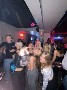 a group of people standing around each other at a party