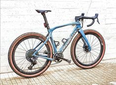 a blue bike parked next to a white wall