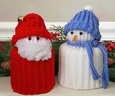 two knitted snowmen sitting next to each other