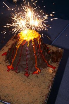 there is a cake that has been decorated with firecrackers and lava on it