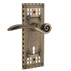 an antique style door handle with decorative design