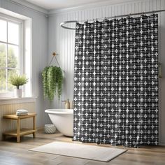 a white bath tub sitting next to a shower curtain in a bathroom under a window