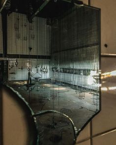 a mirror reflecting the inside of an abandoned building