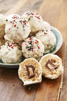 a plate full of cookies with white frosting and sprinkles