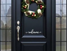 a christmas wreath is hanging on the front door