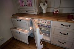 an open refrigerator in a kitchen next to a counter top with drawers and cupboards