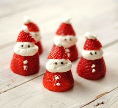 some strawberries with santa clause hats on them