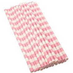 pink and white checkered paper straws are stacked on top of each other,